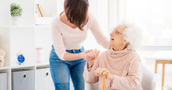 woman helping an elderly person